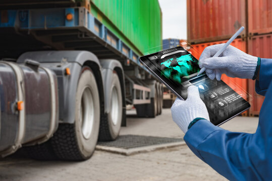 Smart supply chain technology showing gloved hands operating digital tablet interface in industrial transport yard, real image, not AI generated.