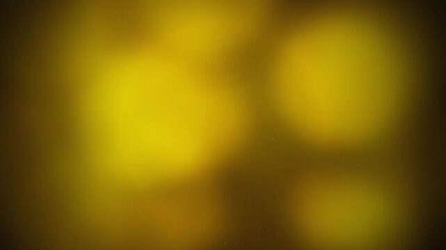 Abstract golden bokeh light particles glowing on dark background, suitable for party backdrop, luxury branding and holiday overlay
