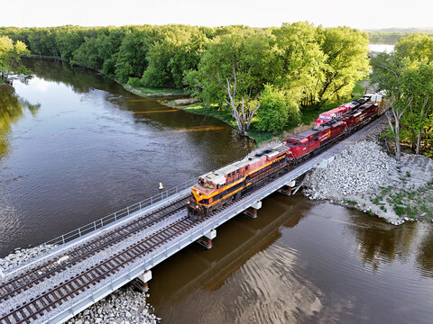 Savanna, Illinois May 10, 2026 Kansas City Southern 4693  locomotive crossing a cement bridge with parallel tracks.