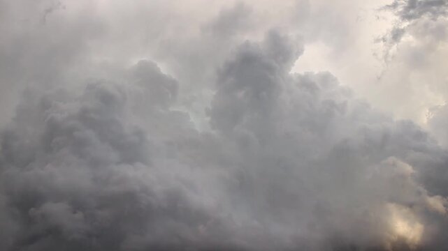 Cumulonimbus clouds billow in the sky as storms move through the area. Time lapse footage. 