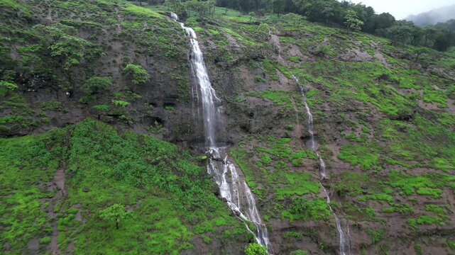Silver Thread on a Green Canvas: The Majestic Cliff Waterfall.