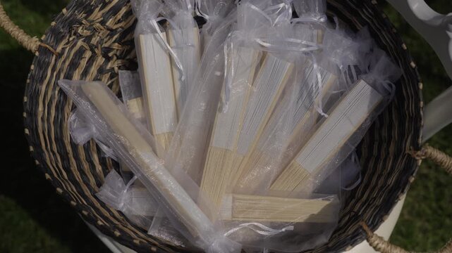 Close-up View of Folding Hand Fans in Organza Pouches as Wedding Favors