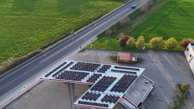 Fuel station with a large rooftop photovoltaic system, Po Valley, Piacenza, Emilia-Romagna, Italy, revealing renewable energy infrastructure, roadside services and surrounding farmland