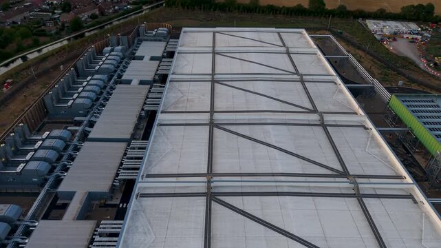 Google data centre Waltham Cross, Hertfordshire rightward pan from rear to front showing roof structure, cooling units, pipework, service corridors and perimeter fencing in the UK.