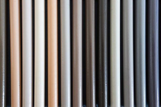 close-up of grey and beige colored pencils neatly lined up in pencil case, concept of creativity, drawing, education and art supplies