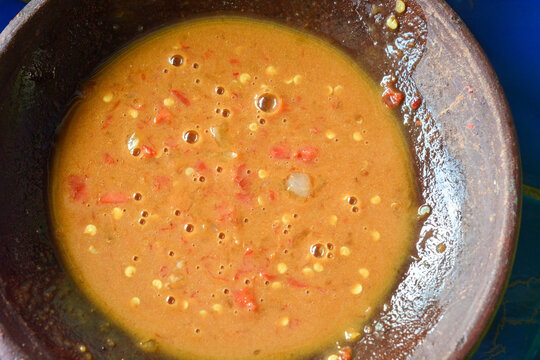 Traditional Indonesian rujak spice paste served in a clay mortar (cobek)