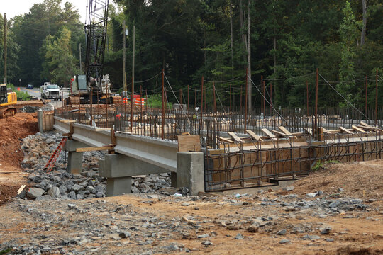 Bridge construction. A construction site featuring reinforced concrete beams and a steel rebar framework during the erection of the bridge structure.