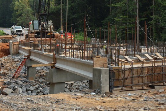 Bridge construction. A construction site featuring reinforced concrete beams and a steel rebar framework during the erection of the bridge structure.