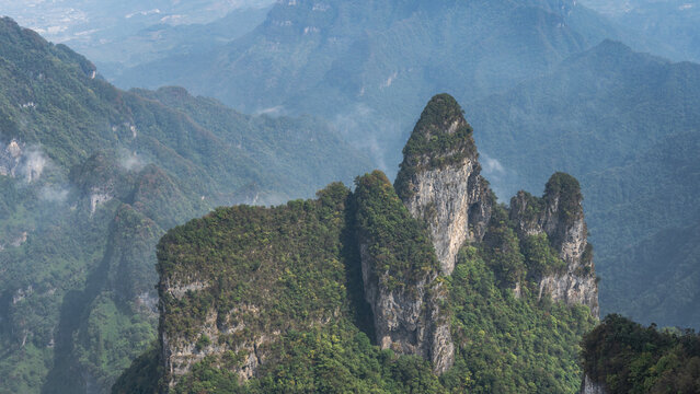 Picturesque mountain landscape. Rocks with bizarre shapes and sharp peaks. There is a green forest on the mountainsides. China. Zhangjiajie. Tianmen  Mountains