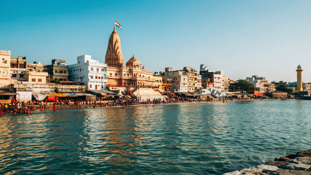 Dwarkadhish temple view from Gomti river bank in Dwarka Gujarat, sacred Hindu pilgrimage site stock photo