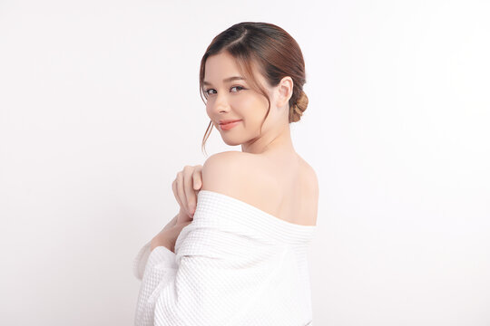 A beautiful young Asian woman with clean, fresh skin against a white background. Skincare, facial treatment, cosmetology, beauty, and spa. An elegant portrait of an Asian woman.