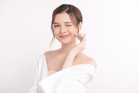 A beautiful young Asian woman with clean, fresh skin against a white background. Skincare, facial treatment, cosmetology, beauty, and spa. An elegant portrait of an Asian woman.