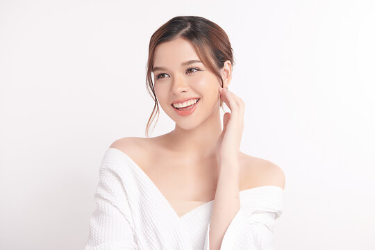 A beautiful young Asian woman with clean, fresh skin against a white background. Skincare, facial treatment, cosmetology, beauty, and spa. An elegant portrait of an Asian woman.