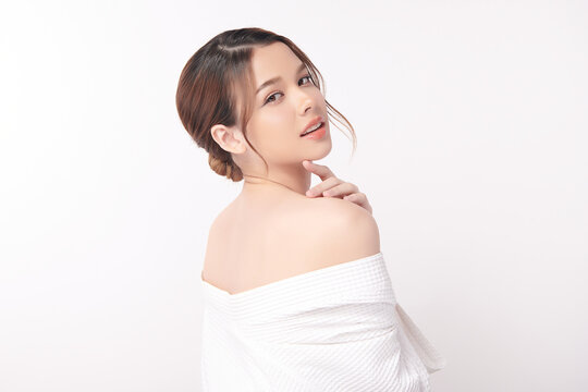 A beautiful young Asian woman with clean, fresh skin against a white background. Skincare, facial treatment, cosmetology, beauty, and spa. An elegant portrait of an Asian woman.