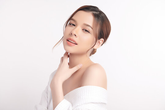 A beautiful young Asian woman with clean, fresh skin against a white background. Skincare, facial treatment, cosmetology, beauty, and spa. An elegant portrait of an Asian woman.