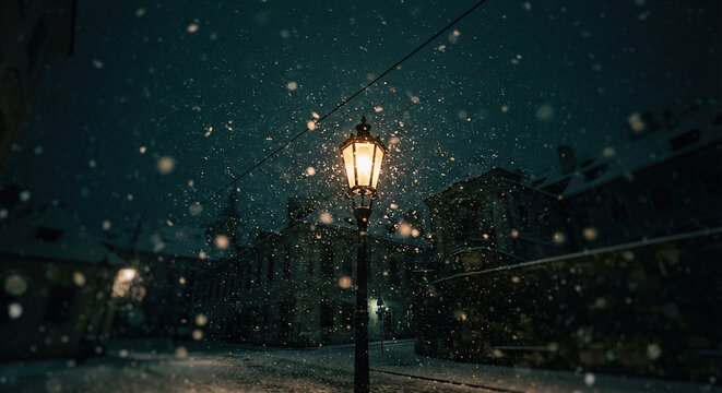 Old street lamp glows gently during heavy snowfall at night