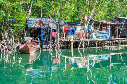 plastic fishernet hangs on the reling of the wooden house in the Mangrove fishermen village at Koh Chang