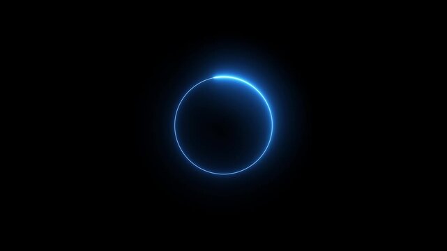 A bright blue neon ring glows against a deep black background creating a celestial or abstract luminous circle effect with a subtle gradient of light intensity around its circumference. Keywords