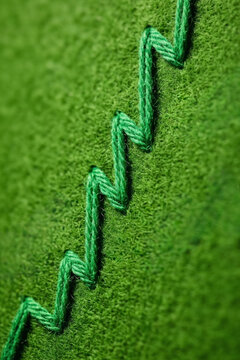 Green zigzag embroidery stitch on fabric