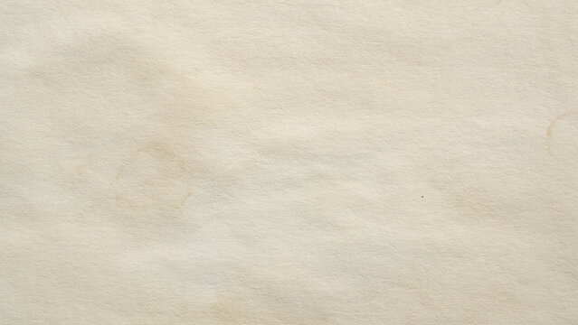 Old vintage paper texture background with aged stains and antique yellowed parchment effect
