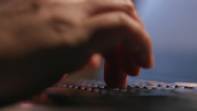 Close‑up of human hands typing on mechanical keyboard, office workspace background, computer work footage
