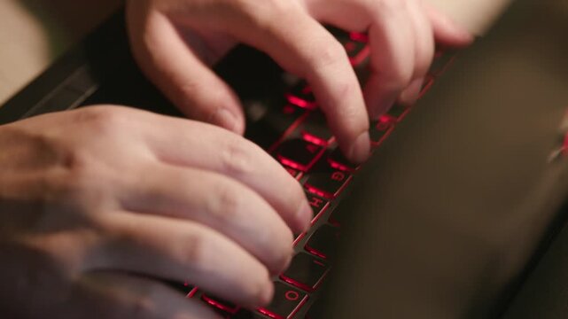 Close‑up of human hands typing on mechanical keyboard, office workspace background, computer work footage