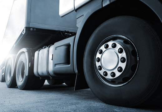 Semi Trailer Trucks on The Parking Lot. Freight Transportation Logistics Truck. Truck Weels. Shipping Cargo Container. Distribution Warehouse. Economy Business Transportation