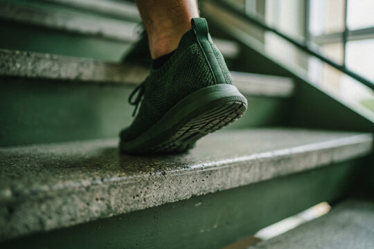 Person walking up concrete stairs