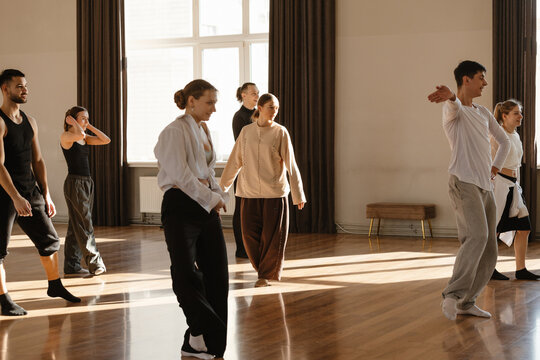 Group of dancers practicing dance in a contemporary dance studio