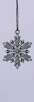 Snowflake-shaped Christmas ornament in black outline, ||black, holiday