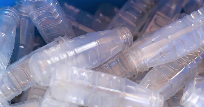 Used clear PET plastic bottles in a recycling bin. plastic waste management, sustainability, circular economy, and environmental conservation concepts, close-up