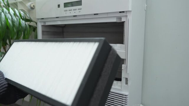 Replacing an old, dirty filter with a new one. Air filters in human hands.