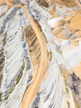 Aerial view of the Hambach open pit mine showing the vast excavation landscape with layered soil, mining tracks, and industrial terrain in Elsdorf, North Rhine-Westphalia, Germany.