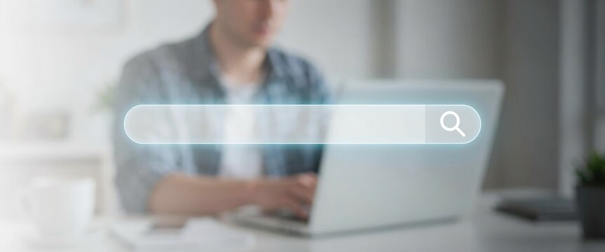 Person using a laptop with a blank search bar overlay computer internet