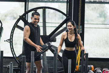 Fototapeta premium Man and woman exercise in gym