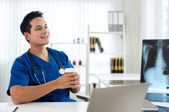 Happy male asian doctor, looks away with smile. Attractive successful man therapist  feel satisfied with career, healthcare mission.