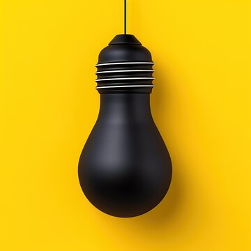 Black hanging lightbulb on yellow background