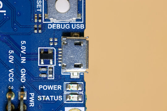 Micro USB port on blue circuit board for electronics, focus stacked image.