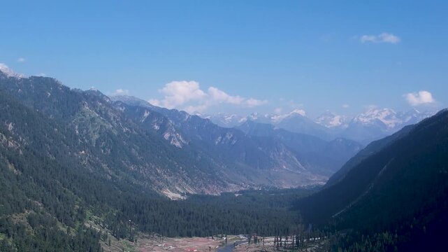 Forested mountain valley stretches toward snow-capped peaks, Upper Dir Valley, Kumrat, Pakistan
