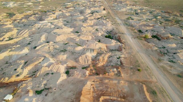 Arid Landscape, Opal Mining Piles, And Dirt Roads Of Coober Pedy In South Australia - High Angle Aerial Drone Shot
