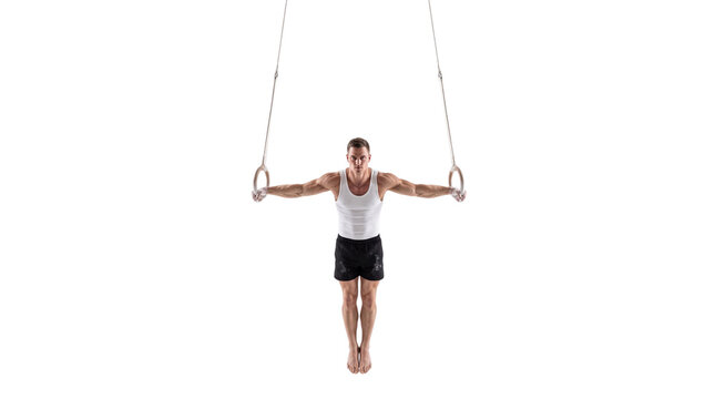 Athletic male gymnast performing iron cross on rings, muscular man training gymnastics strength, fitness athlete workout isolated PNG with Transparent Background