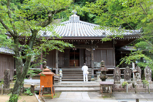 Daishido Hall and Praying Pilgrim at Yakuoji Temple on Shikoku Henro Pilgrimage in Minami, Tokushima, Japan 2026