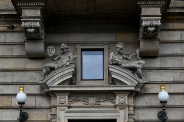 Ornate window with decorative stone brackets and lamp posts on a building facade, Prague, Czech Republic © IbrahimAlkan