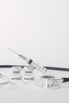 Professional medical peptide injection syringe with vial and stethoscope in clean wellness clinic offering hopeful preventative medicine