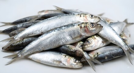 Obraz premium Fresh fish piled on white surface, ready for cooking