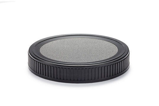 Black plastic lid of jar isolated on white background