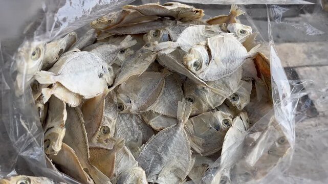 Traditional salted dried fish inside transparent plastic wrap