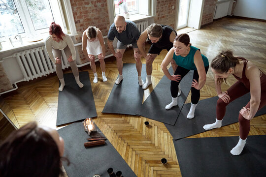 Yoga class stretching exercises during a wellness class in a yoga studio