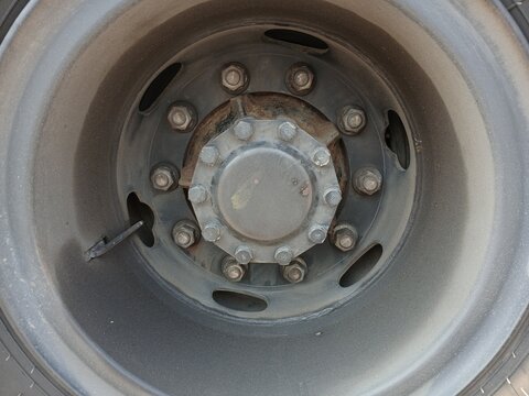 Close-Up Of Heavy Duty Truck Wheel Hub And Lug Nuts