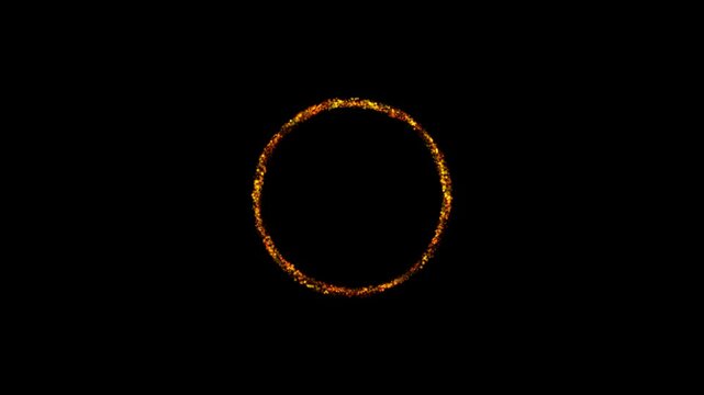 A glowing circle frame made of bright orange fire sparks burning in the darkness for a magical effect